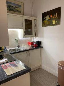a kitchen with a sink and a counter top at Cozy Cottage - Near Brew Pub / Snowdonia National Park. in Caernarfon