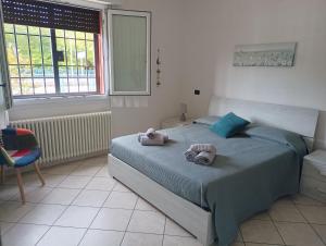 a bedroom with a bed with towels on it at Sisters Home in Bologna