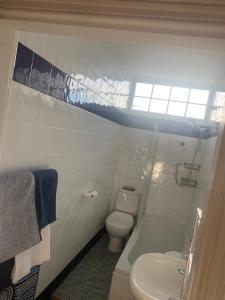 a white bathroom with a toilet and a sink at Top Floor. Top Notch. Tranquil Treat. Stone's throw from Thames. in Maidenhead