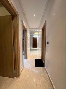 a hallway with a black object on the floor at Luxueuse appartement in Agadir