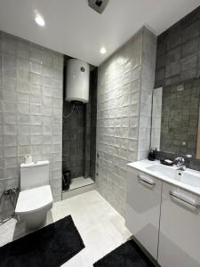 Luxueuse appartement في أغادير: حمام مع مرحاض ومغسلة ودش