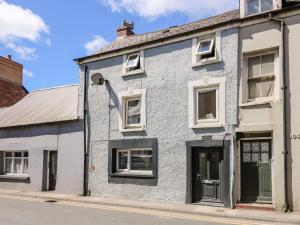 a blue and white house on a street at Lane Cottage in Cardigan