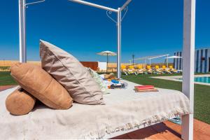 a table with pillows on it next to a pool at Casa Rural Reifs 