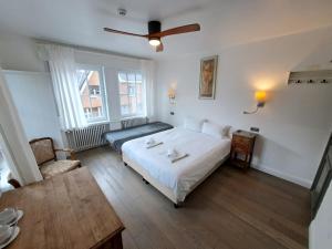 a bedroom with a bed and a table in it at B&B Pickery in Bruges