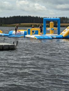 a group of people are on an inflatable raft in the water at Loch's Heaven 67 in Balminnoch