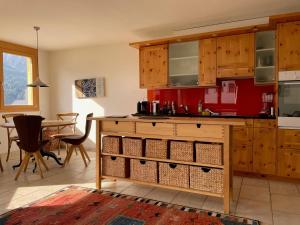 a kitchen with wooden cabinets and a table at Costa dad Archas B5 in Sent