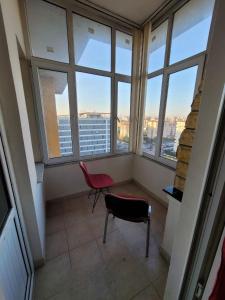 a room with two chairs and two windows at Journey's Ease in Istanbul