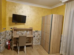a room with a table and a television on a wall at Hotel Ristorante "Da Valerio" in Cittaducale