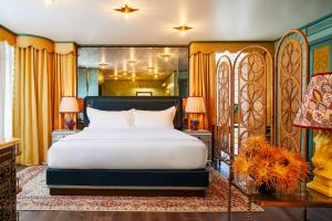 a bedroom with a large bed in a room at The Fifth Avenue Hotel in New York