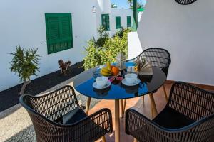 a table and chairs with a bowl of fruit on it at Casa Luna in Puerto del Carmen