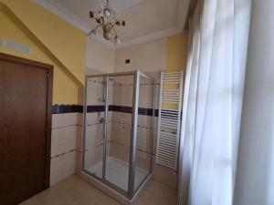 a bathroom with a walk in shower and a chandelier at Hotel Ristorante "Da Valerio" in Cittaducale +25 photos