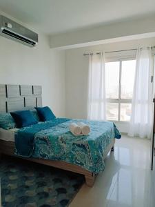 a bedroom with a bed with two towels on it at Omas Ocean in Porlamar