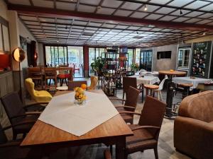 a dining room with a table and chairs at Logis Central Hôtel & Spa in Bort-les-Orgues