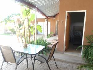 a patio with a table and chairs on a porch at Aub Guesthouse - Mariental in Mariental