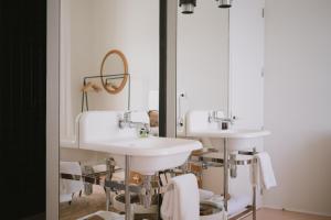 a bathroom with three sinks and a mirror at Can Set in Cadaqués