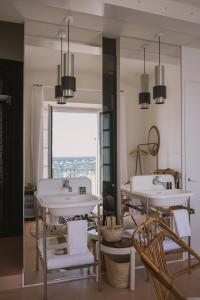 a bathroom with two sinks and a large mirror at Can Set in Cadaqués