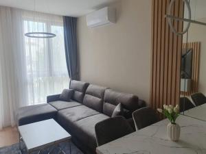 a living room with a couch and a table at Apartament Harmony in Sunny Beach