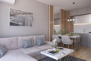 a living room with a couch and a table at Apartament Harmony in Sunny Beach