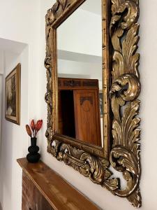 an ornate mirror on a wall in a room at CivicoNove in Piombino