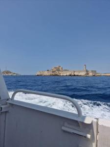 a boat in the water with a view of the ocean at Une parenthèse au Frioul in Marseille