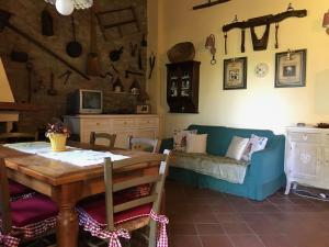 a dining room with a table and a couch at Il Forcone in Panicale +22 photos