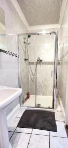 a bathroom with a shower and a sink at Aldgate Rooms in London