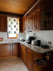 a kitchen with wooden cabinets and a counter top at Guesthouse Emiljano in Berat