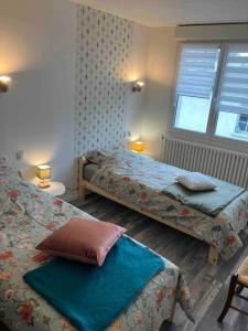 a bedroom with two beds and a window at Maison avec jardin à Laon / House with Garden in Laon in Laon