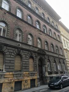 a brick building with a car parked in front of it at Ó 38 Luxe Loft in Budapest