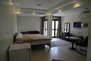 a bedroom with a bed and a desk and a table at Cairo international Scout House in Cairo
