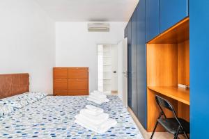 a bedroom with a bed and a desk and a chair at Milan - Bocconi e Navigli - Spacious 3BR Apartment 95 m - Free Parking in Milan +14 photos