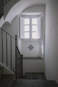 a stairway with a window and a stair case at Can Set in Cadaqués
