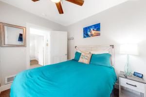 a bedroom with a large bed with blue sheets at Berni's Crow's Nest in Oceanside