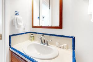 a bathroom with a white sink and a mirror at Berni's Crow's Nest in Oceanside +22 photos