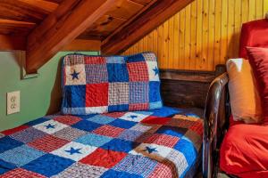 a quilt sitting on a bed in a room at Lazy Fox Hideout in Sevierville