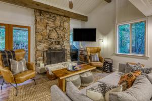 a living room with a stone fireplace and furniture at Inviting Tahoe Escape in Incline Village