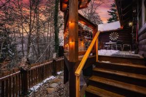 a stairway leading to a cabin with a deck at Lazy Fox Hideout in Sevierville