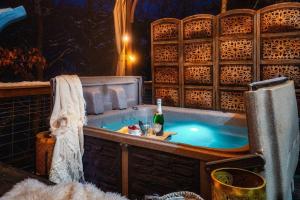 a bath tub with a bottle of wine in it at Lazy Fox Hideout in Sevierville