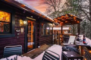 a cabin with a deck in the snow at Lazy Fox Hideout in Sevierville