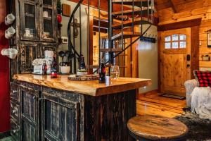 a kitchen with a wooden island in a cabin at Lazy Fox Hideout in Sevierville