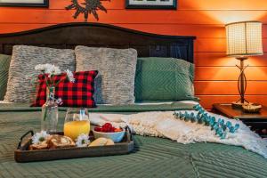a tray of food sitting on top of a bed at Lazy Fox Hideout in Sevierville