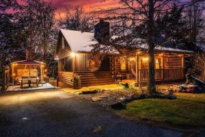 a log cabin with christmas lights on it at Lazy Fox Hideout in Sevierville