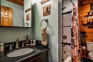 a bathroom with a sink and a shower at Lazy Fox Hideout in Sevierville