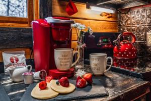 a kitchen counter with a blender and strawberries on it at Lazy Fox Hideout in Sevierville