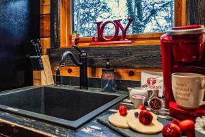 a kitchen counter with a sink with strawberries on it at Lazy Fox Hideout in Sevierville