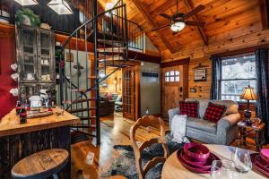 a living room with a spiral staircase in a cabin at Lazy Fox Hideout in Sevierville