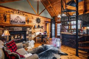 a living room with a fireplace and a stone wall at Lazy Fox Hideout in Sevierville