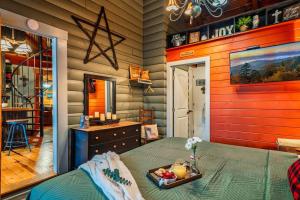 a bedroom with a bed with a tray of fruit on it at Lazy Fox Hideout in Sevierville