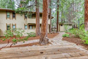 a house in the woods with a wooden walkway at Inviting Tahoe Escape in Incline Village