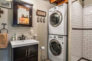 a bathroom with a washer and dryer next to a sink at Lazy Fox Hideout in Sevierville